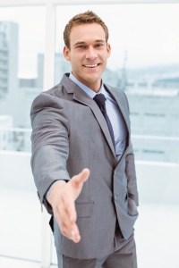 Portrait of smart businessman offering handshake