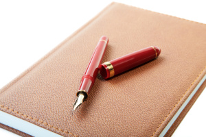 fountain pen close-up and  leather organizer isolated on a white