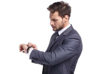 young business man  looking at watch over white background